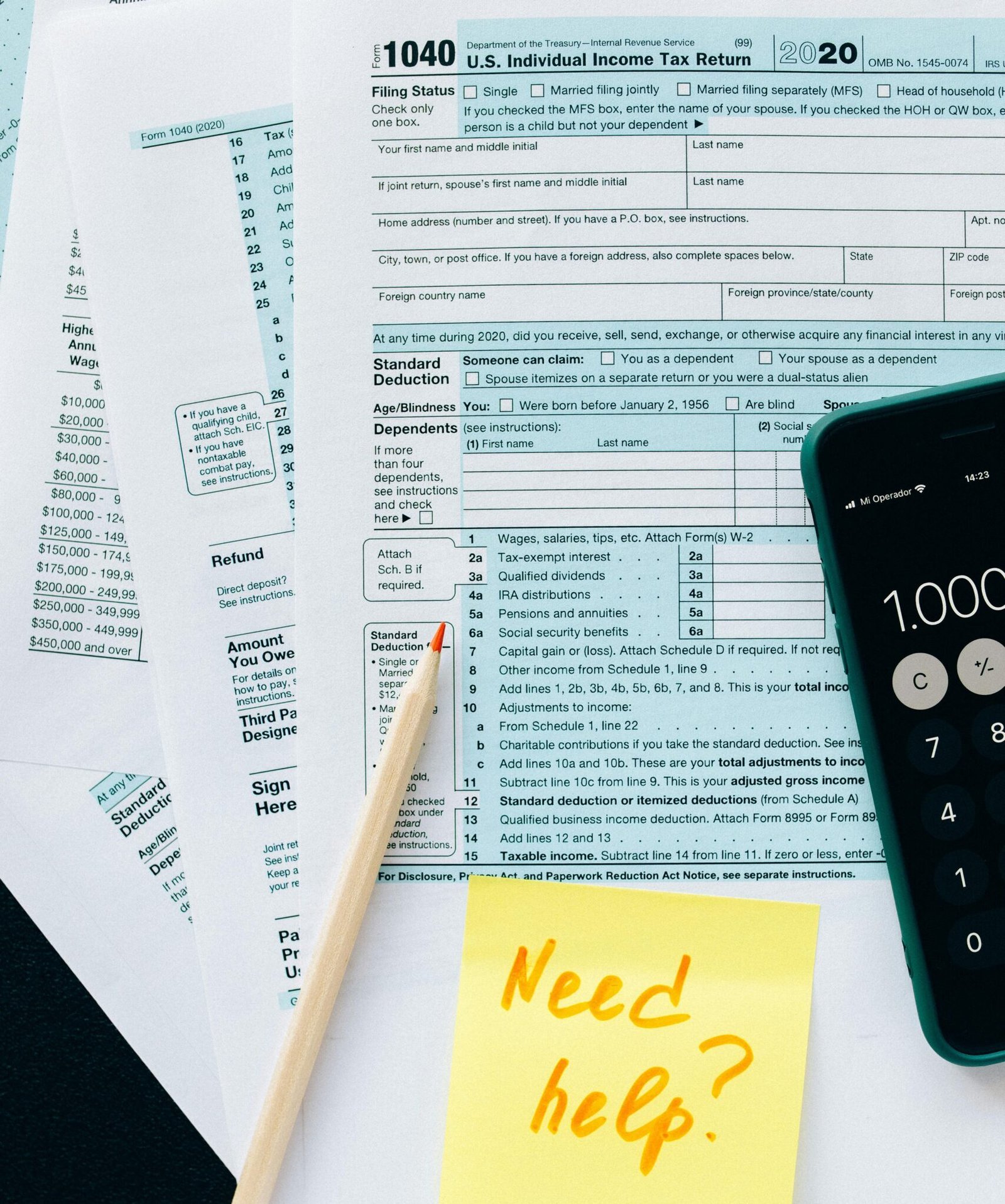 Close-up of tax forms with a calculator and a note asking for assistance.